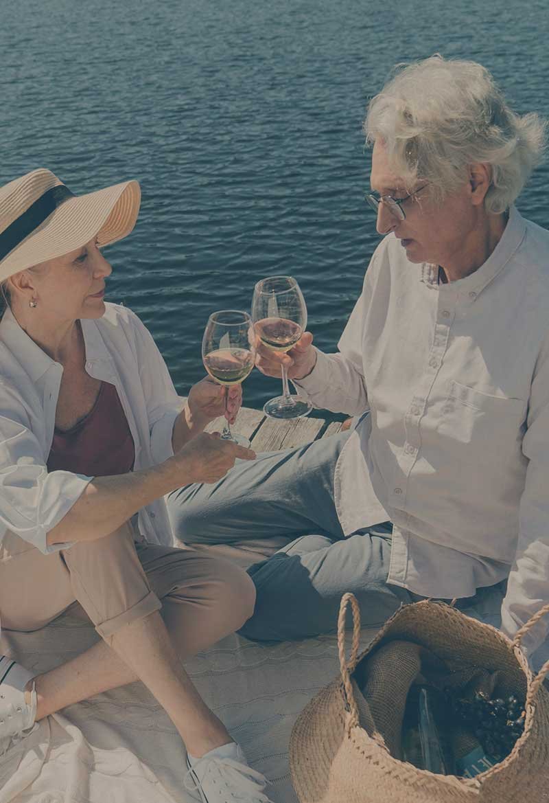 Older couple on a boat date enjoying wine. dinner cruise kelowna